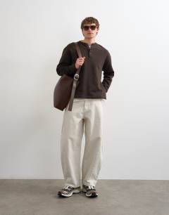 Model wearing Relaxed fit henley sweatshirt in brown