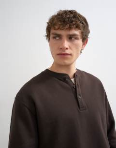 Model wearing Relaxed fit henley sweatshirt in brown