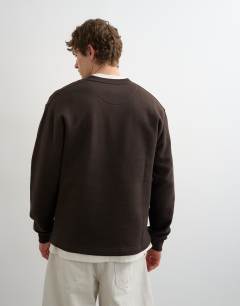 Model wearing Relaxed fit henley sweatshirt in brown