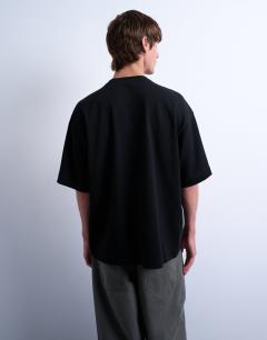 Model wearing Relaxed fit interlock t-shirt with floral embroidery in black