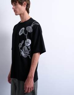 Model wearing Relaxed fit interlock t-shirt with floral embroidery in black