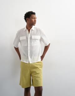 Model wearing Relaxed fit jersey short in washed yellow