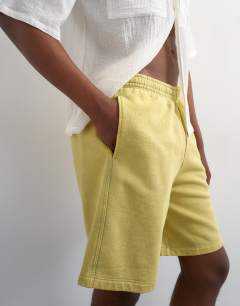 Model wearing Relaxed fit jersey short in washed yellow