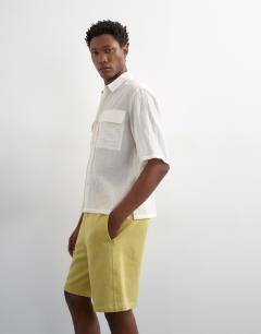 Model wearing Relaxed fit jersey short in washed yellow