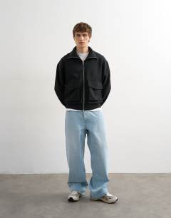 Model wearing Relaxed fit jersey utility shacket with funnel in black