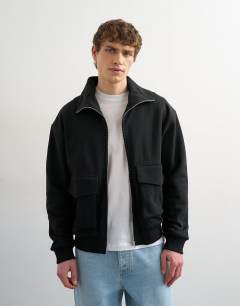 Model wearing Relaxed fit jersey utility shacket with funnel in black
