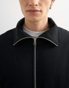 Model wearing Relaxed fit jersey utility shacket with funnel in black