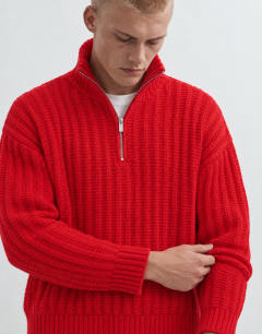 Model wearing Relaxed fit knitted 1/4 zip funnel neck knitted jumper in red