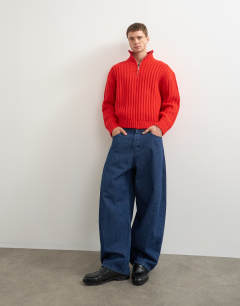 Model wearing Relaxed fit knitted 1/4 zip funnel neck knitted jumper in red