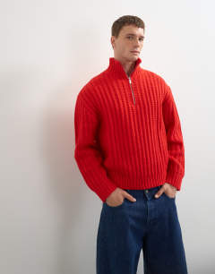 Model wearing Relaxed fit knitted 1/4 zip funnel neck knitted jumper in red