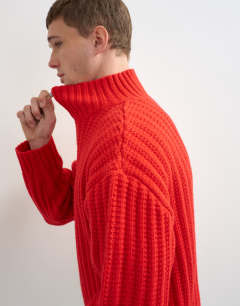 Model wearing Relaxed fit knitted 1/4 zip funnel neck knitted jumper in red