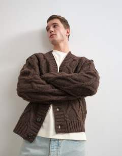 Model wearing Relaxed fit knitted cable cardigan in brown