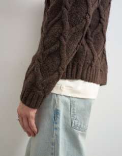 Model wearing Relaxed fit knitted cable cardigan in brown