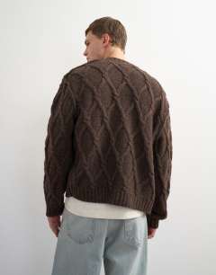 Model wearing Relaxed fit knitted cable cardigan in brown