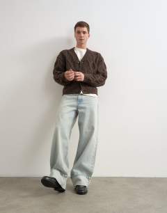 Model wearing Relaxed fit knitted cable cardigan in brown