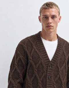 Model wearing Relaxed fit knitted cable cardigan in brown