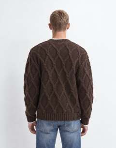 Model wearing Relaxed fit knitted cable cardigan in brown