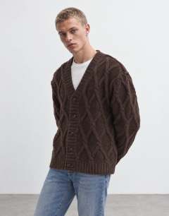Model wearing Relaxed fit knitted cable cardigan in brown