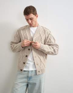 Model wearing Relaxed fit knitted cable cardigan in oatmeal