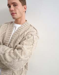 Model wearing Relaxed fit knitted cable cardigan in oatmeal