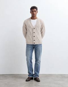Model wearing Relaxed fit knitted cable cardigan in oatmeal