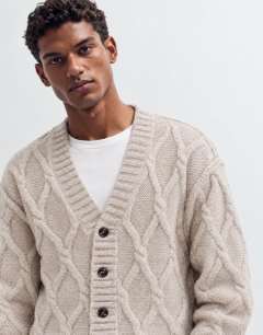 Model wearing Relaxed fit knitted cable cardigan in oatmeal