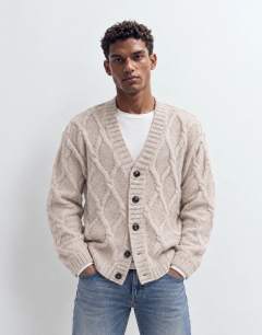Model wearing Relaxed fit knitted cable cardigan in oatmeal