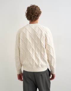 Model wearing Relaxed fit knitted cable jumper in ecru