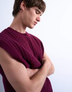 Model wearing Relaxed fit knitted cable tank in burgundy