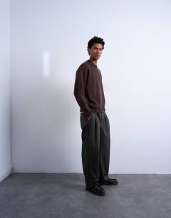 Model wearing Relaxed fit knitted crew neck jumper in brown