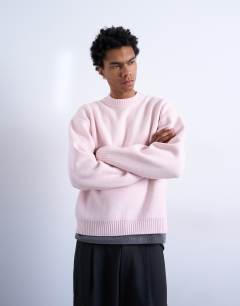Model wearing Relaxed fit knitted crew neck jumper in pink