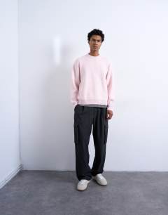 Model wearing Relaxed fit knitted crew neck jumper in pink