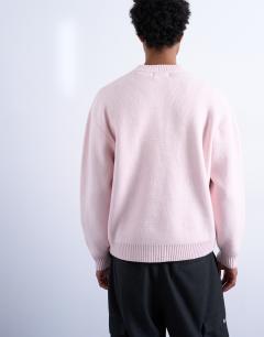 Model wearing Relaxed fit knitted crew neck jumper in pink