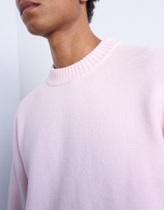 Model wearing Relaxed fit knitted crew neck jumper in pink