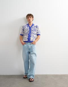 Model wearing Relaxed fit knitted shirt with all over boucle floral applique in blue