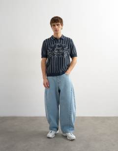 Model wearing Relaxed fit knitted stripe polo with east side jacquard in navy