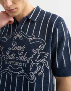 Model wearing Relaxed fit knitted stripe polo with east side jacquard in navy