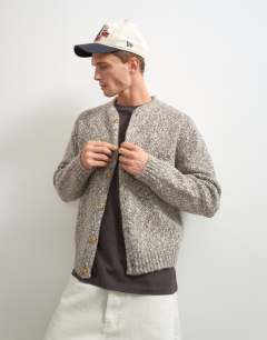 Model wearing Relaxed fit knitted twist cardigan with notch neck in light taupe