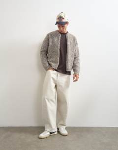 Model wearing Relaxed fit knitted twist cardigan with notch neck in light taupe