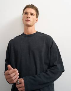 Model wearing Relaxed fit layered t-shirt with waffle sleeve in washed black