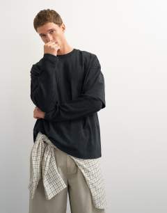 Model wearing Relaxed fit layered t-shirt with waffle sleeve in washed black
