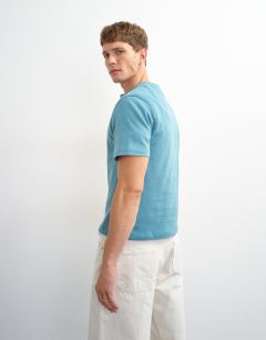 Model wearing Relaxed fit linen mix henley t-shirt in petrol blue