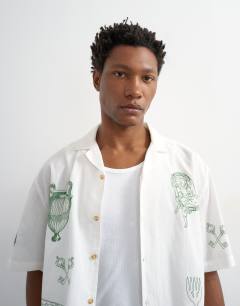 Model wearing Relaxed fit linen mix shirt with all over placement embroidery in ecru