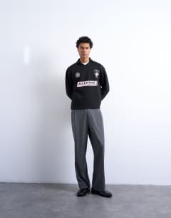 Model wearing Relaxed fit long sleeve sports polo shirt with Marseille back embroidery in black 