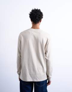 Model wearing Relaxed fit long sleeve t shirt in stone