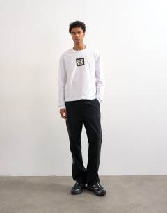 Model wearing Relaxed fit long sleeve t-shirt with studio print in white