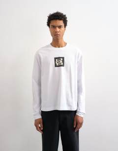 Model wearing Relaxed fit long sleeve t-shirt with studio print in white