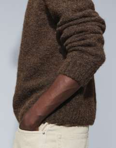 Model wearing Relaxed fit loose knit jumper in brown
