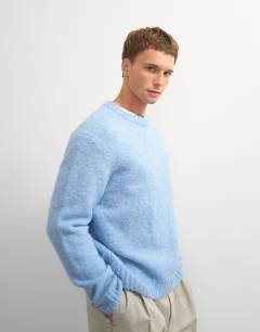 Model wearing Relaxed fit loose knit jumper in light blue