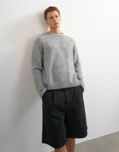Model wearing Relaxed fit loose knit jumper in light grey